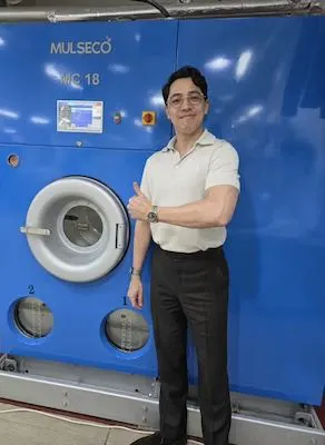 Ryan in front of dry cleaning machine